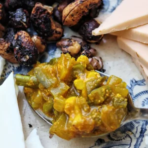 Our homemade Piccalilly Circus on a plate with some cheese and roasted nuts.